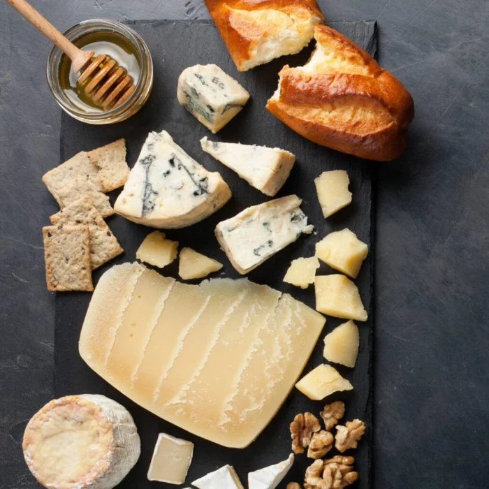 assortment of cheese, crackers, and bread