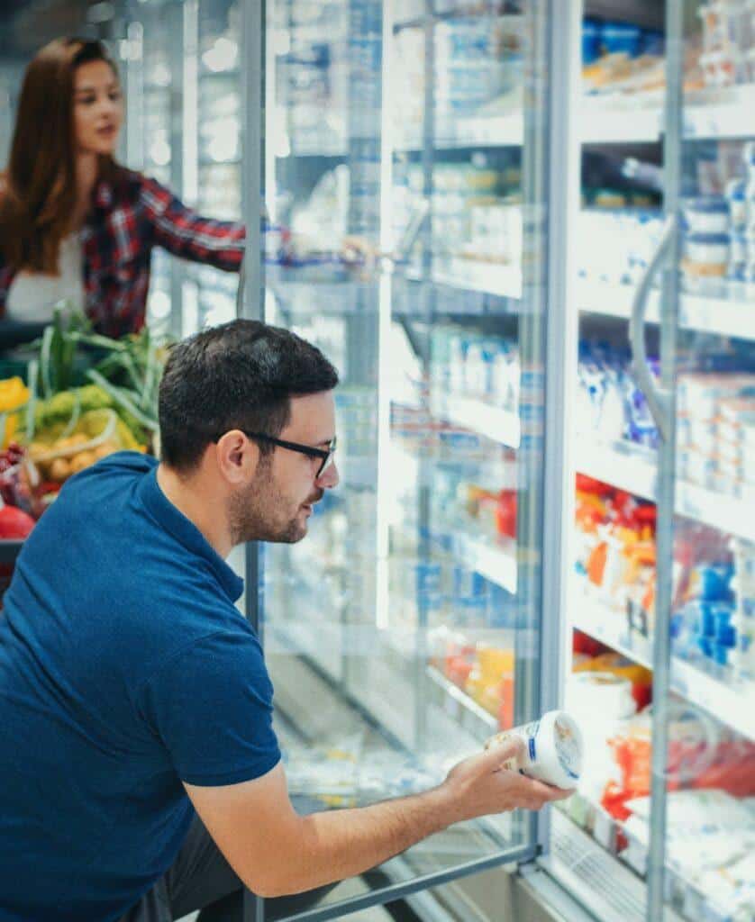 people doing groceries on the dairy aisle