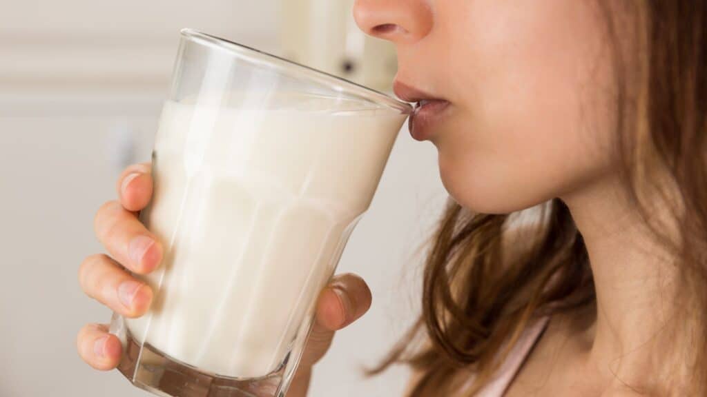 Creamy milk being sipped by a woman, close-up