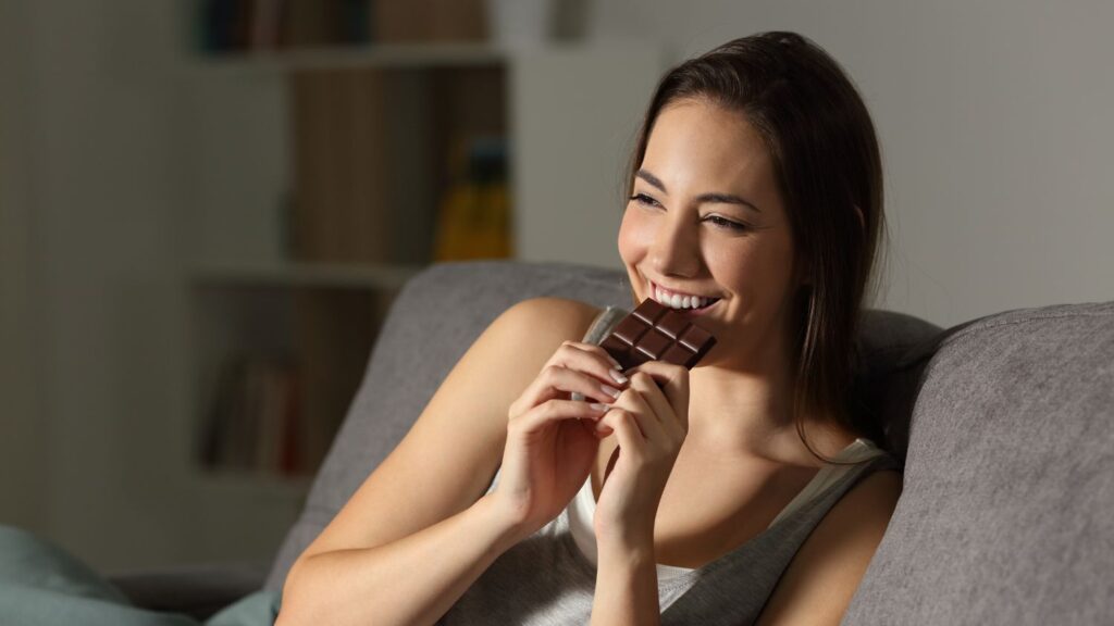 woman eating a functiuonal sweet brown chocolate